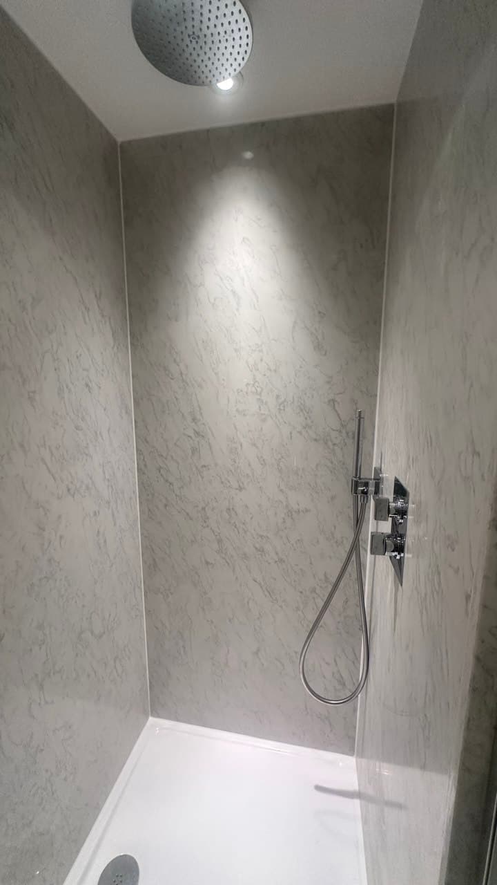 Detail of the shower controls and ceiling-mounted rain head