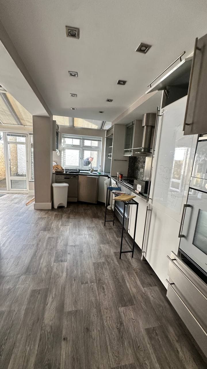 Kitchen installation with stone surfaces and fitted cabinetry